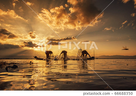 Intha Burmese fishermen on boat catching fish traditional at Inle Lake, Shan State, Myanmar Intha Burmese fishermen on boat catching fish traditional at Inle Lake, Shan State, Myanmar 66688350