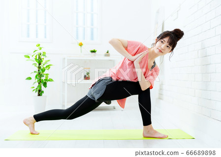 Young woman doing yoga at home 66689898