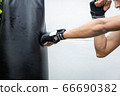The man hit to bag on boxing training, he has 66690382