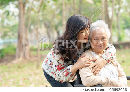 Help and care Asian senior or elderly old lady woman patient sitting on wheelchair 66692628