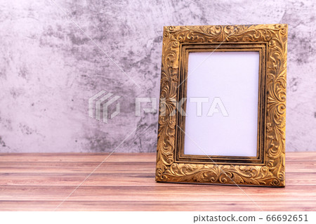 Picture frame on wall background and wooden table. Picture frame on wall background and wooden table. 66692651