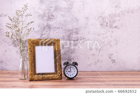 Picture frame and flowers and clock on wooden Picture frame and flowers and clock on wooden 66692652