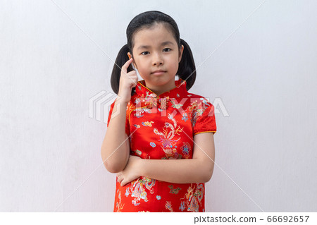 Asian girl wear cheongsam thinking Asian girl wear cheongsam thinking 66692657
