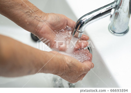 Asian senior or elderly old lady woman patient washing hand by soap Asian senior or elderly old lady woman patient washing hand by soap 66693894