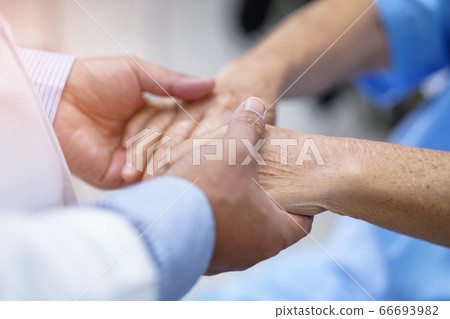Doctor holding hands Asian senior or elderly old lady woman patient with love Doctor holding hands Asian senior or elderly old lady woman patient with love 66693982