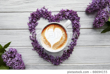 Lilac flowers and cup of coffee 66694155