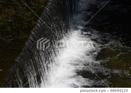 Abstract background of nature-Splash of stream weir 66694224
