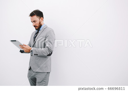 Serious male CEO is reading resume specialists before interview 66696811