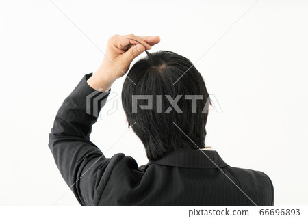 Businessman who is concerned about light hair Businessman who is concerned about light hair 66696893