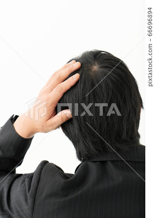 Businessman who is concerned about light hair 66696894