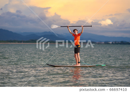 Man on stand up paddle. Water and beach sport Man on stand up paddle. Water and beach sport 66697410