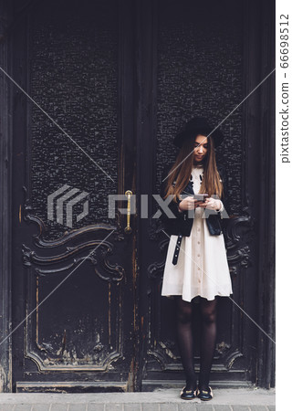 Young charming female with beautiful long hair posing with cell telephone Young charming female with beautiful long hair posing with cell telephone 66698512