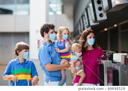 Family in airport in face mask. Virus outbreak. Family in airport in face mask. Virus outbreak. 66698529