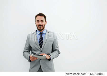 Serious male CEO is reading resume specialists before interview 66698880