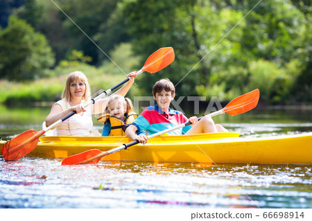 Child on kayak. Kids on canoe. Summer camping. 66698914