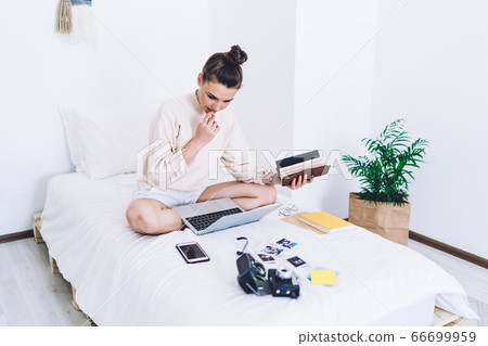 Pensive female working at laptop at home Pensive female working at laptop at home 66699959