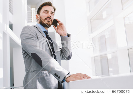 Intelligent male lawyer working on touch pad during work break Intelligent male lawyer working on touch pad during work break 66700075
