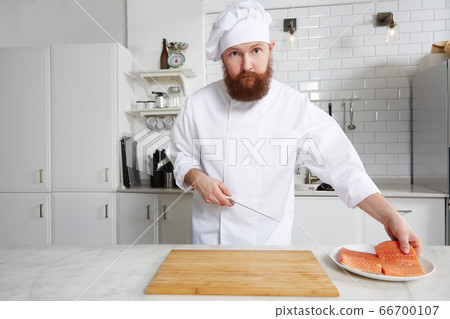 Male chef preparing gourmet meal of seafood in modern kitchen 66700107