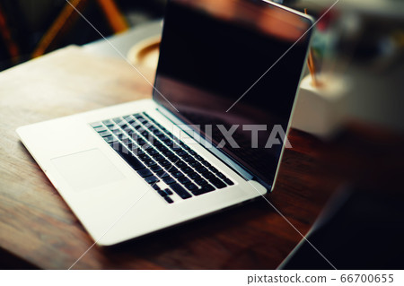 Workplace with open laptop with black screen on modern wooden desk Workplace with open laptop with black screen on modern wooden desk 66700655