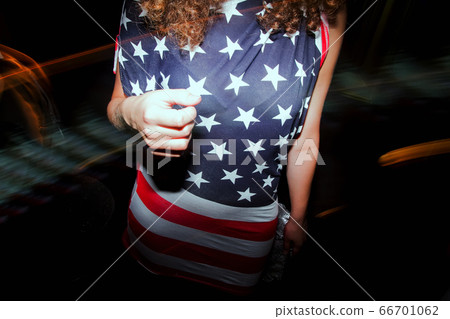 girl wearing american flag t-shirt standing in disco girl wearing american flag t-shirt standing in disco 66701062