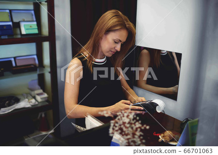 Young Caucasian woman shop owner enjoying entrepreneurship business 66701063