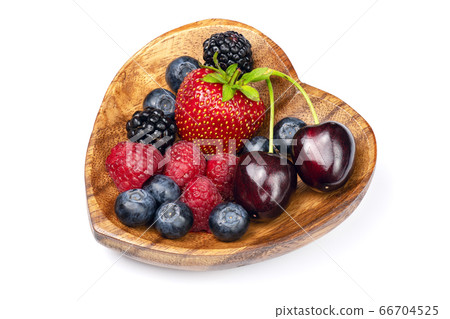 Fresh different berries in wooden bowl. 66704525