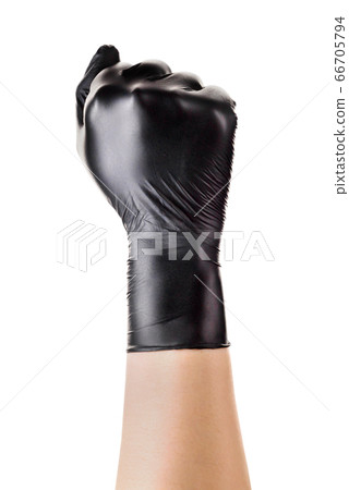 Hand in black gloves showing clenched fist Hand in black gloves showing clenched fist 66705794