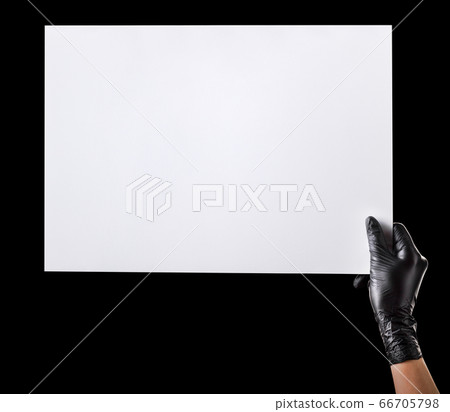 Hand in black gloves holding blank cardboard Hand in black gloves holding blank cardboard 66705798
