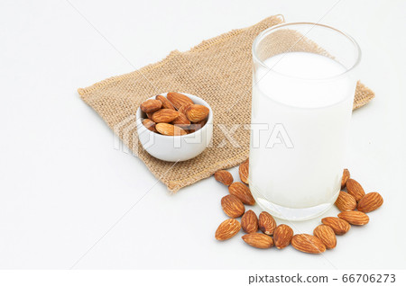 Milk Almonds in a glass on a white background Milk Almonds in a glass on a white background 66706273