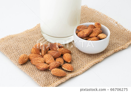 Milk Almonds in a glass on a white background Milk Almonds in a glass on a white background 66706275