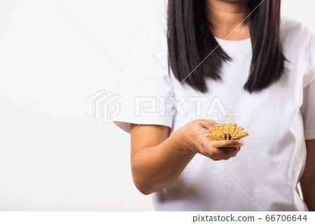 Woman weak hair she shows hairbrush with damaged Woman weak hair she shows hairbrush with damaged 66706644