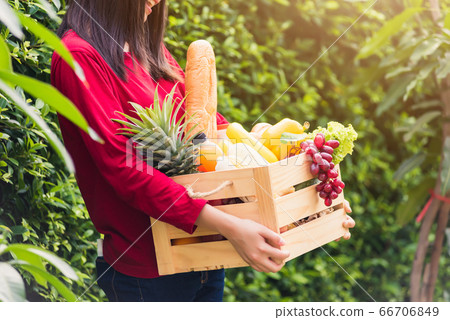 Woman farmer standing hold full fresh food raw 66706849
