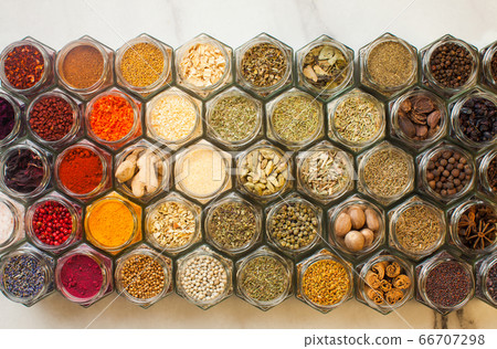 Assorted spices pattern top view in hexagon bottles in the kitchen 66707298