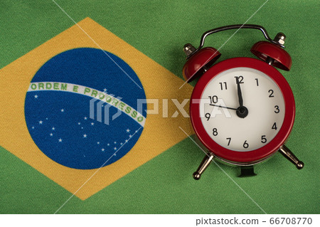 Brazil flag and vintage alarm clock. Time to Brazil flag and vintage alarm clock. Time to 66708770