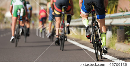 Group of cyclist at professional race, cyclists in a road race stage 66709186