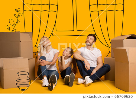 Family with child dreaming about new furnished apartment on orange background with doodle drawings Family with child dreaming about new furnished apartment on orange background with doodle drawings 66709620