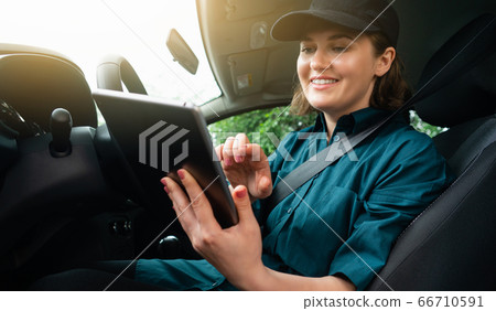 Woman courier with digital tablet Woman courier with digital tablet 66710591