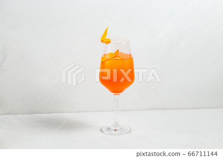 Fresh fruit yellow alcohol cocktail in wine glass  66711144