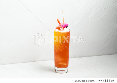 Fresh fruit yellow alcohol cocktail in a highball Fresh fruit yellow alcohol cocktail in a highball 66711146