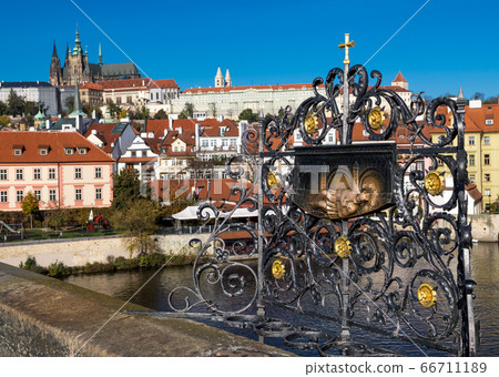 Bronze Sculpture Of Saint John Of Nepomuk On Charles Bridge In Front Of Hradzany Castle And Saint Vitus Cathedral In Prague In The Czech Republic Bronze Sculpture Of Saint John Of Nepomuk On Charles Bridge In Front Of Hradzany Castle And Saint Vitus Cathedral In Prague In The Czech Republic 66711189