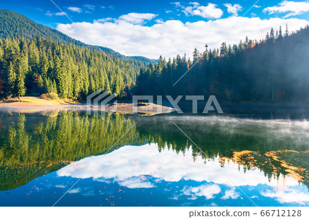 lake landscape at foggy sunrise. misty scenery lake landscape at foggy sunrise. misty scenery 66712128