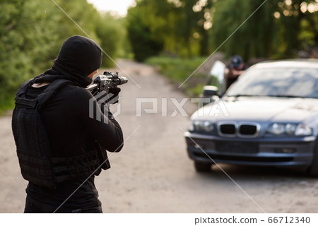 Shootout between a police officer and a offender. Stop Terrorism and Crime. The police officer and the terrorist are aiming each other. 66712340