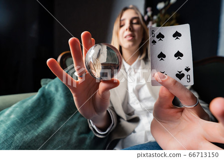 Woman in business suit holding crystal ball and six spade Woman in business suit holding crystal ball and six spade 66713150