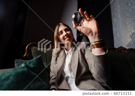 Woman in business suit holding crystal ball Woman in business suit holding crystal ball 66713151
