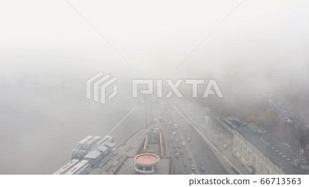 A city covered in fog. City traffic, aerial view 66713563