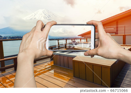 Girl taking pictures on mobile smart phone in Girl taking pictures on mobile smart phone in 66715066
