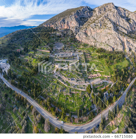 Aerial view of antique Theatre and Apollo Temple in Delphi, Greece at sunrise, famous archaeological site in Greece, Morning fog over mountains, hoarfrost on roofs Aerial view of antique Theatre and Apollo Temple in Delphi, Greece at sunrise, famous archaeological site in Greece, Morning fog over mountains, hoarfrost on roofs 66715080