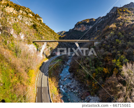 The mountain river along the Road, Aerial panoramic drone view of a scenic highway by the beautiful Landscape covered in clouds and fog, bridge and viaduct, The mountain river along the road, 66715081