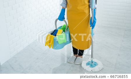 Woman housekeeper with mop and bucket with 66716855