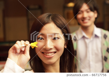 A couple doing darts 66717756